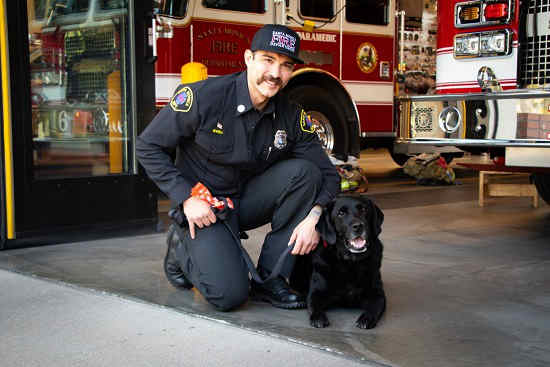 Roger the service  dog with firefighter